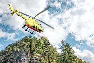 Helikopter w górach lecący na akcję ratunkową - z assistance turystycznym koszt takiej akcji może zostać pokryty przez ubezpieczyciela.