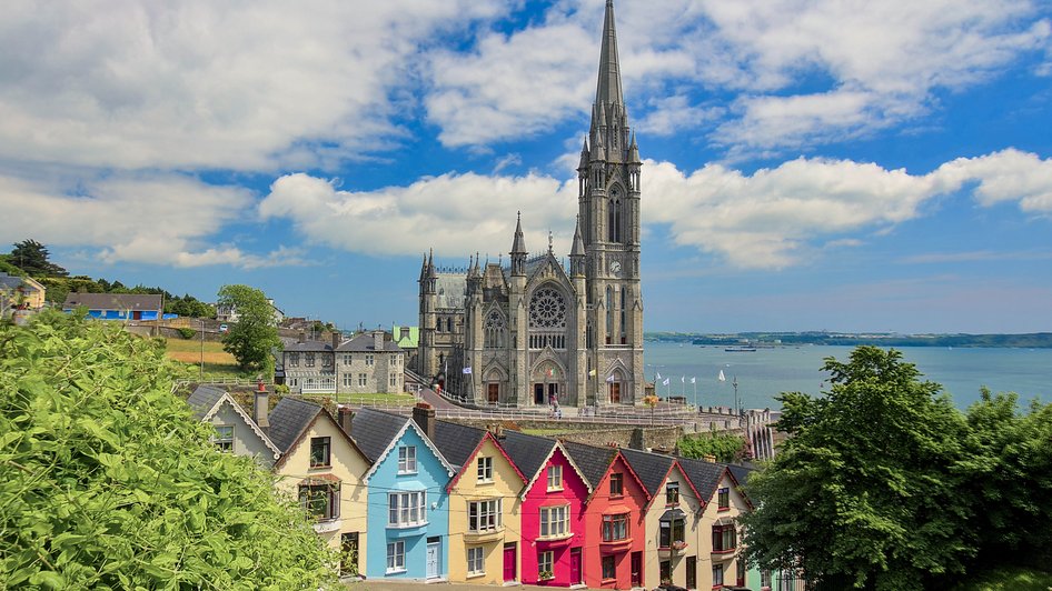Kolorowe, irlandzie domki widziane na tle katedry Świętego Kolmana w Cork