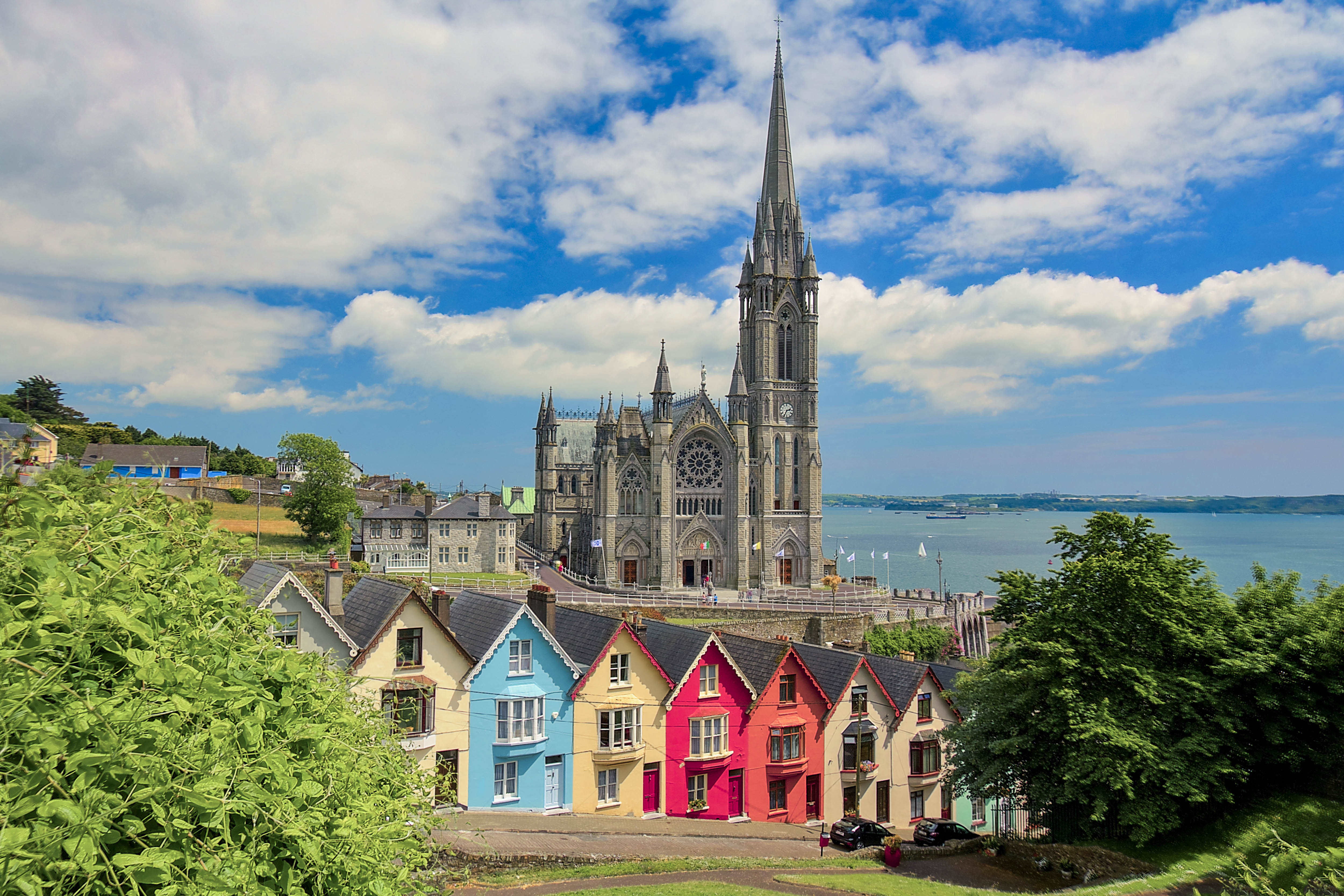 Urlop w Irlandii - Ubezpieczenie turystyczne Kolorowe, irlandzie domki widziane na tle katedry Świętego Kolmana w Cork
